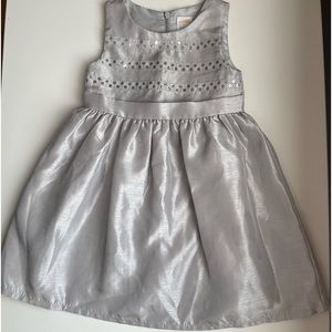 A beautiful soft gray satin dress with shiny silver circles imprinted.